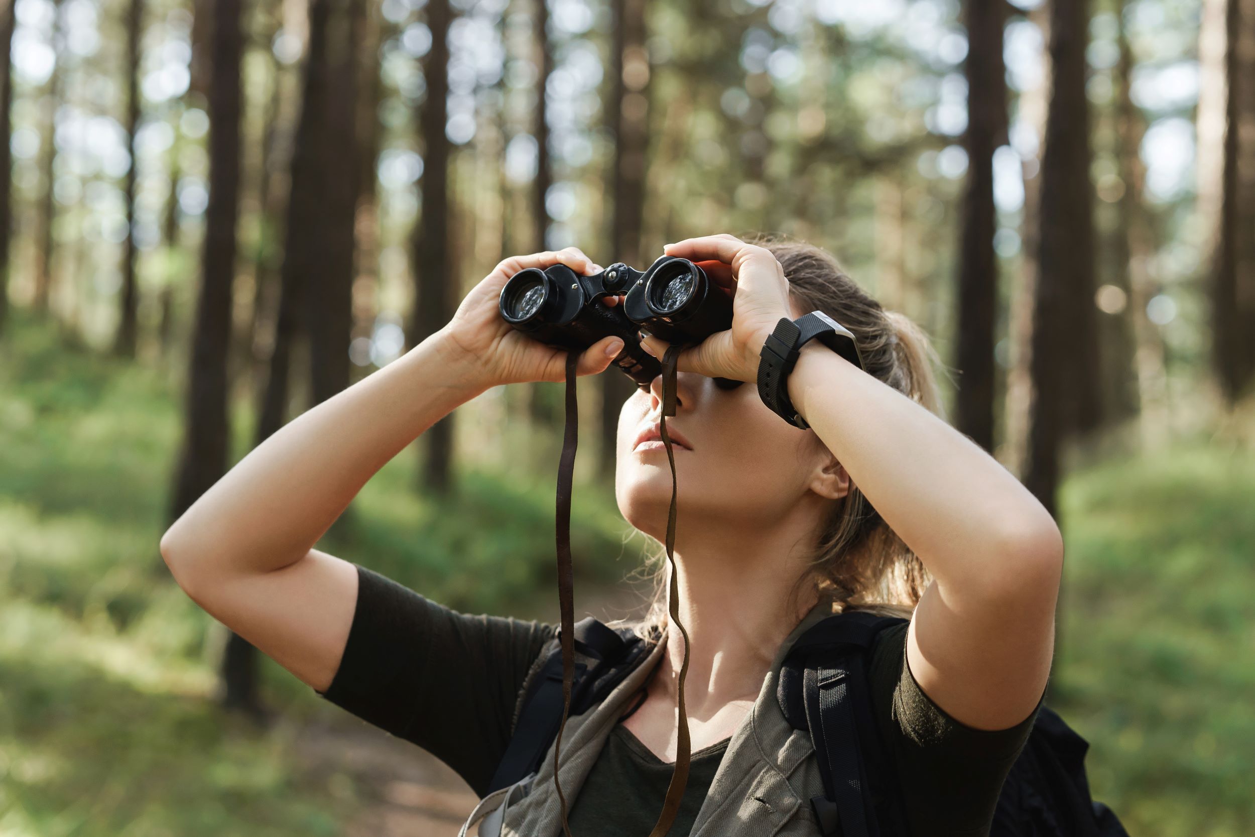 A woman birdwatching.