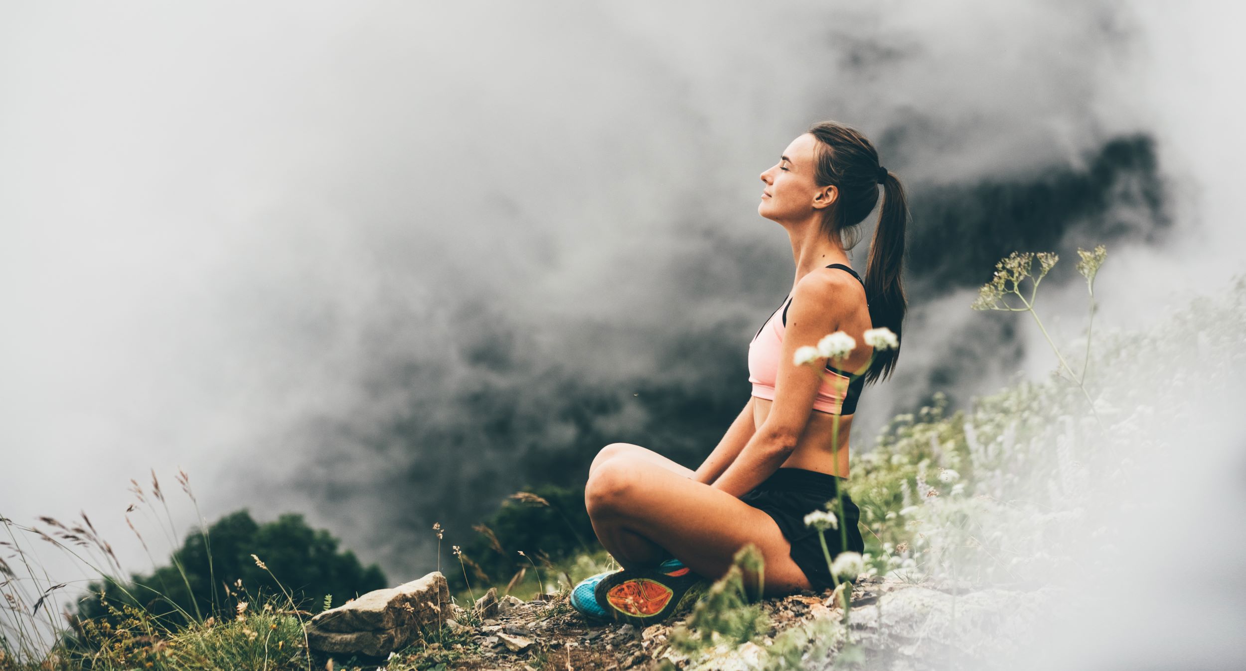 A woman doing yoga outdoors.